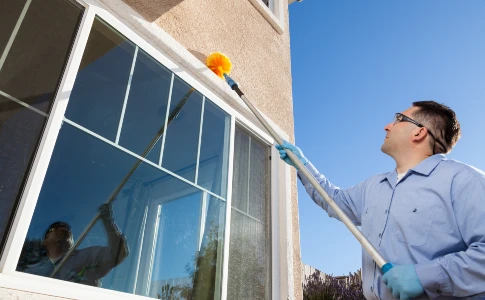 Technician web dusting around window